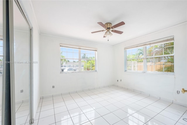 30 E 52nd Pl, Hialeah, FL 33013 - tiled empty room featuring plenty of natural light, ceiling fan, and crown molding