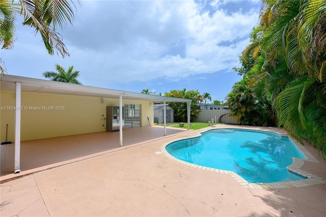 30 E 52nd Pl, Hialeah, FL 33013 - view of swimming pool featuring a storage unit, a patio, and a fenced backyard