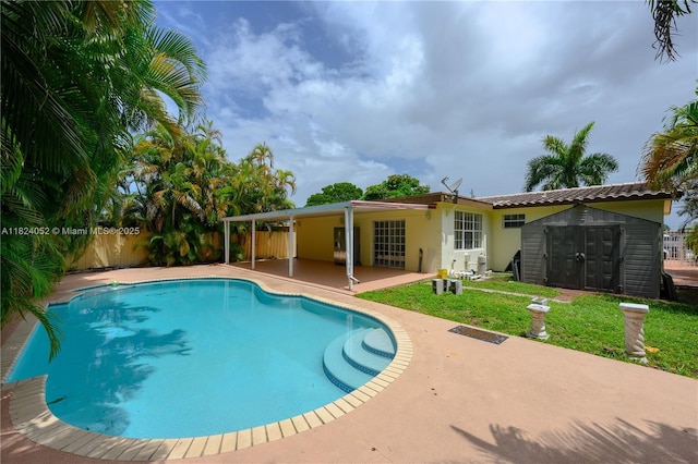 30 E 52nd Pl, Hialeah, FL 33013 - view of swimming pool featuring a patio, a storage shed, and a fenced backyard