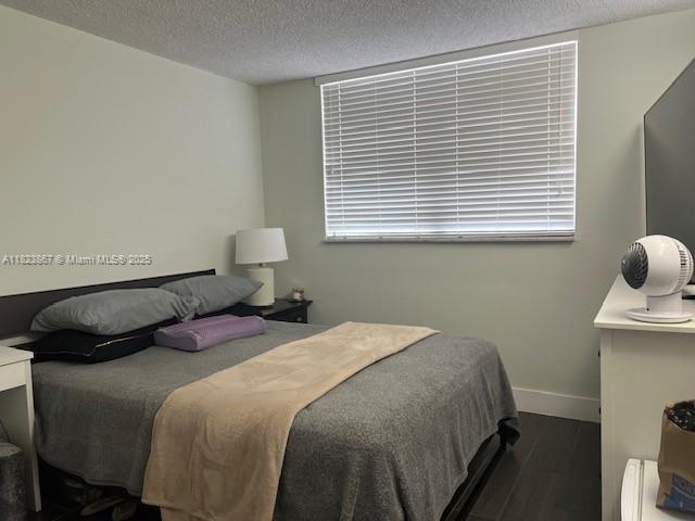 14165 SW 87th St Unit D202, Miami, FL 33183 - bedroom with wood finished floors and a textured ceiling