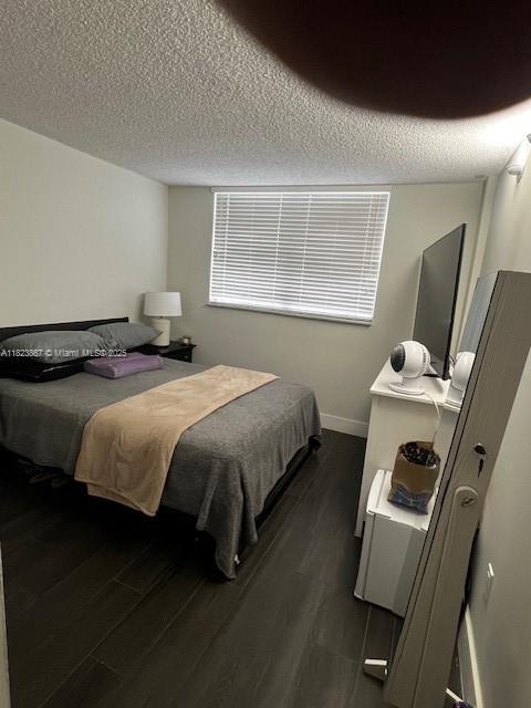 14165 SW 87th St Unit D202, Miami, FL 33183 - bedroom with dark wood-style flooring and a textured ceiling