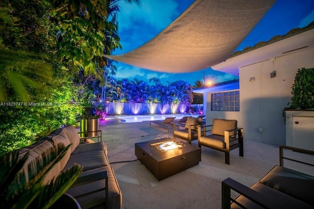 11530 NE 7th Ave, Biscayne Park, FL 33161 - patio at night with an outdoor living space with a fire pit and a patio area