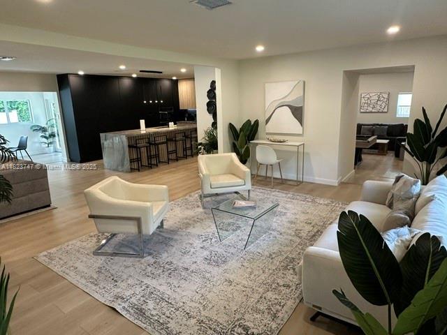 11530 NE 7th Ave, Biscayne Park, FL 33161 - living area featuring plenty of natural light, light wood-style floors, and recessed lighting
