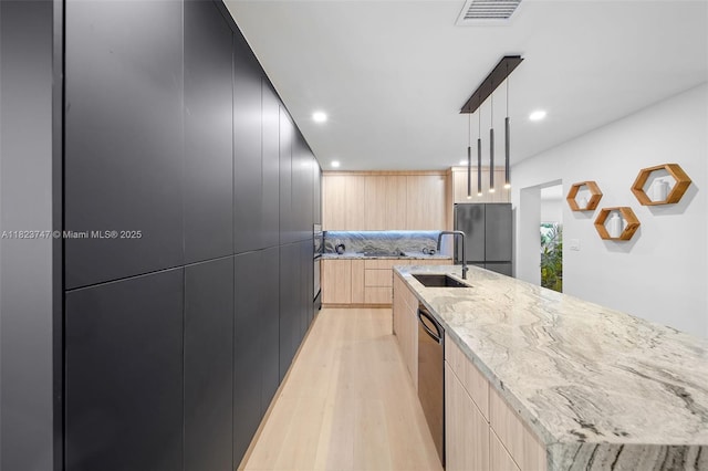 11530 NE 7th Ave, Biscayne Park, FL 33161 - kitchen featuring modern cabinets, light brown cabinetry, freestanding refrigerator, light wood finished floors, and recessed lighting