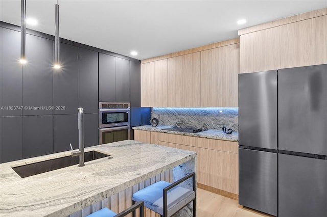 11530 NE 7th Ave, Biscayne Park, FL 33161 - kitchen with stainless steel appliances, light brown cabinets, modern cabinets, light stone countertops, and recessed lighting