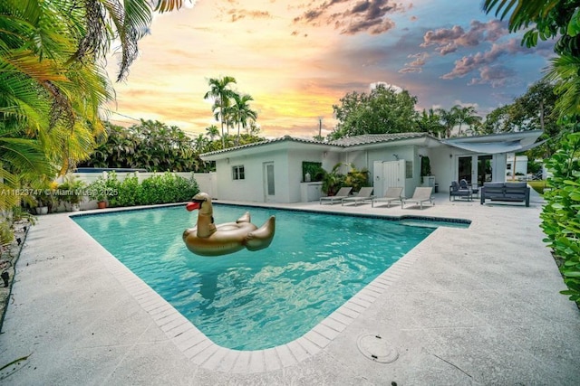 11530 NE 7th Ave, Biscayne Park, FL 33161 - pool at dusk featuring a patio area