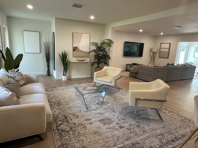11530 NE 7th Ave, Biscayne Park, FL 33161 - living room featuring wood finished floors and recessed lighting