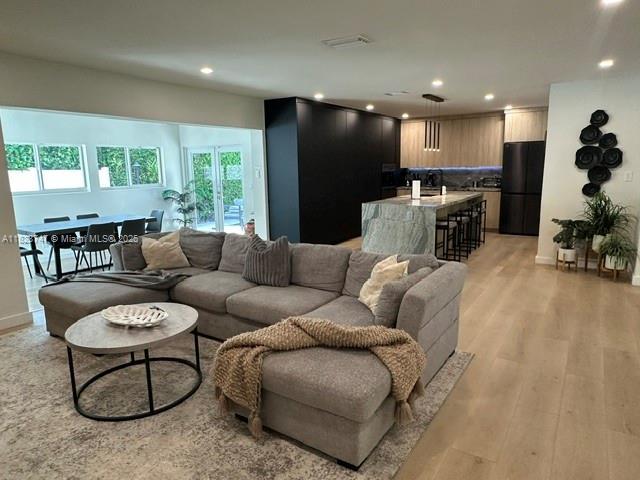 11530 NE 7th Ave, Biscayne Park, FL 33161 - living room with recessed lighting and light wood-type flooring