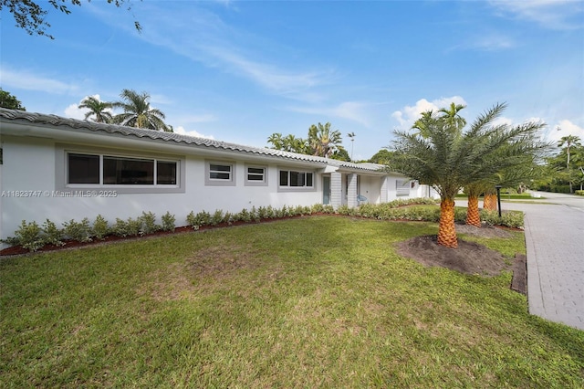 11530 NE 7th Ave, Biscayne Park, FL 33161 - view of front of home featuring a front lawn, stucco siding, and a tile roof
