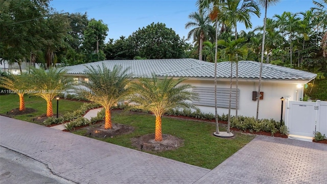 11530 NE 7th Ave, Biscayne Park, FL 33161 - view of side of home with a gate, a tile roof, and stucco siding