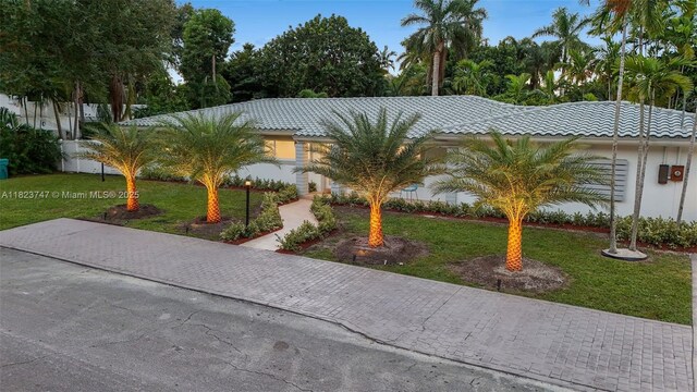 11530 NE 7th Ave, Biscayne Park, FL 33161 - view of front of property featuring a front lawn, a tiled roof, and stucco siding