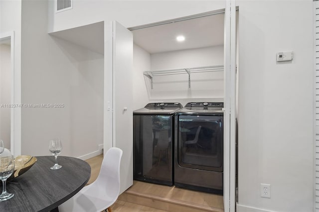 11530 NE 7th Ave, Biscayne Park, FL 33161 - washroom with independent washer and dryer and light wood-style flooring