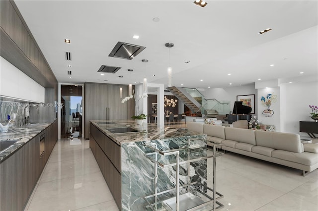 6000 Island Blvd Unit Ph7, Aventura, FL 33160 - kitchen featuring modern cabinets, a large island, open floor plan, dark stone countertops, and recessed lighting