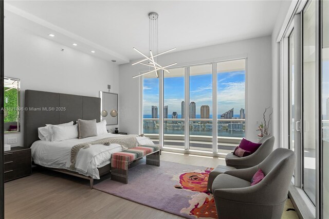6000 Island Blvd Unit Ph7, Aventura, FL 33160 - bedroom with wood finished floors, a water view, recessed lighting, a chandelier, and a view of skyline