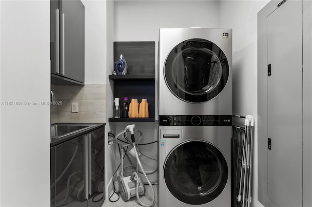 6000 Island Blvd Unit Ph7, Aventura, FL 33160 - washroom with stacked washer / dryer and cabinet space