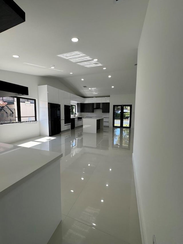 1205 Wallace St, Coral Gables, FL 33134 - hallway featuring vaulted ceiling, light tile patterned floors, and recessed lighting