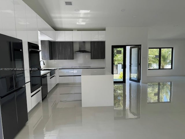 1205 Wallace St, Coral Gables, FL 33134 - kitchen with modern cabinets, wall chimney exhaust hood, black appliances, and white cabinets