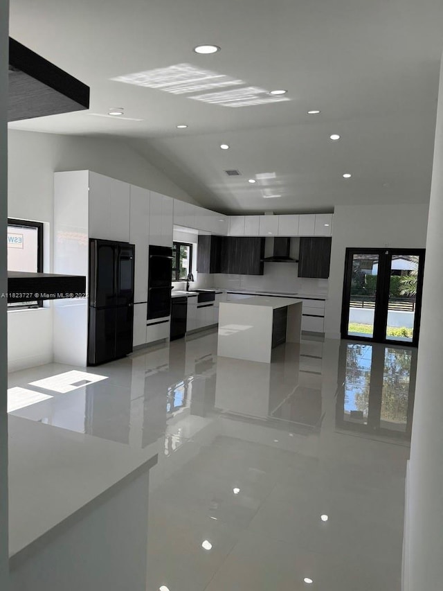 1205 Wallace St, Coral Gables, FL 33134 - kitchen with modern cabinets, freestanding refrigerator, white cabinets, vaulted ceiling, and a kitchen island