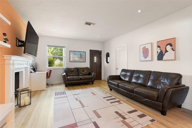 3422 SW 25th St, Miami, FL 33133 - living area with light wood-style flooring, a fireplace, and recessed lighting