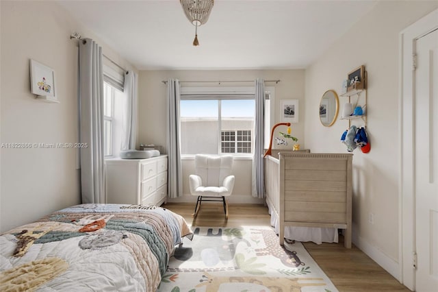 3422 SW 25th St, Miami, FL 33133 - bedroom with light wood-type flooring and baseboards