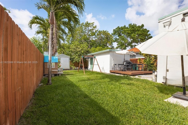 3422 SW 25th St, Miami, FL 33133 - fenced backyard featuring a storage unit and a deck