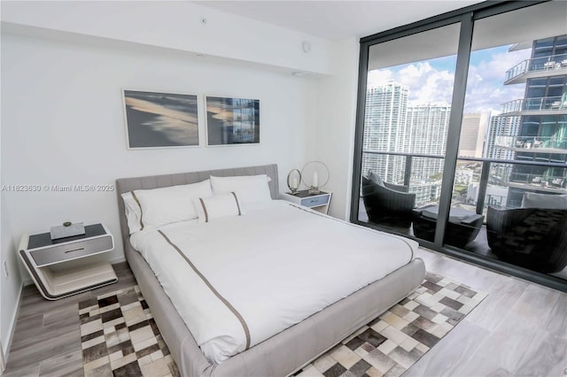 801 S Miami Ave Unit 3108, Miami, FL 33130 - bedroom featuring floor to ceiling windows, a view of city, and wood finished floors