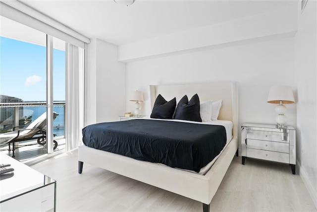 465 Brickell Ave Unit 2003, Miami, FL 33131 - bedroom featuring wood finished floors, access to exterior, and a wall of windows
