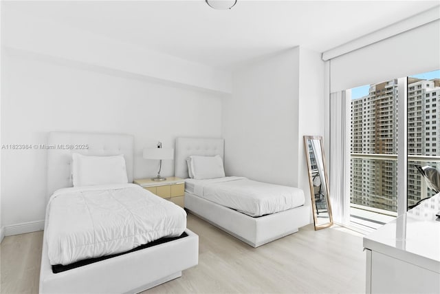 465 Brickell Ave Unit 2003, Miami, FL 33131 - bedroom featuring light wood-type flooring and floor to ceiling windows