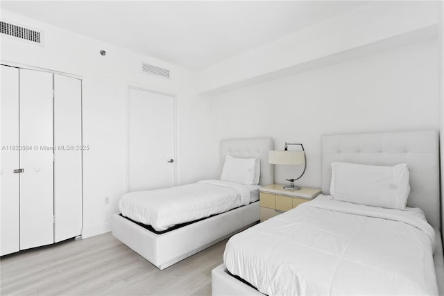 465 Brickell Ave Unit 2003, Miami, FL 33131 - bedroom featuring light wood-style flooring and a closet