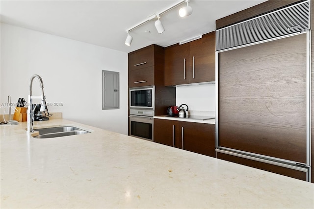 465 Brickell Ave Unit 2003, Miami, FL 33131 - kitchen with built in appliances, dark brown cabinets, electric panel, and rail lighting