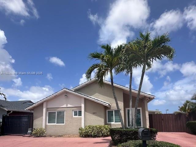 641 SW 99th Pl, Miami, FL 33174 - view of front facade featuring stucco siding and a gate
