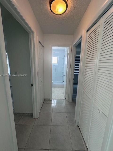 641 SW 99th Pl, Miami, FL 33174 - hall featuring a textured ceiling and light tile patterned floors