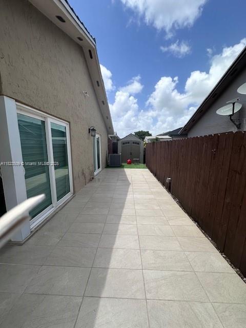 641 SW 99th Pl, Miami, FL 33174 - view of patio featuring a storage shed