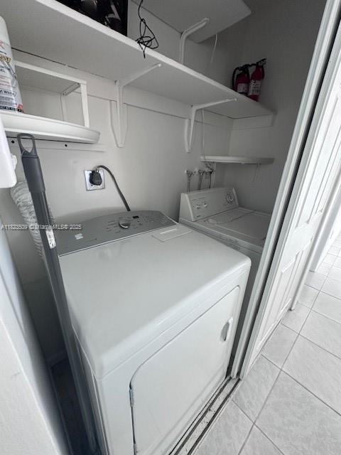 641 SW 99th Pl, Miami, FL 33174 - washroom with washer and clothes dryer and light tile patterned floors