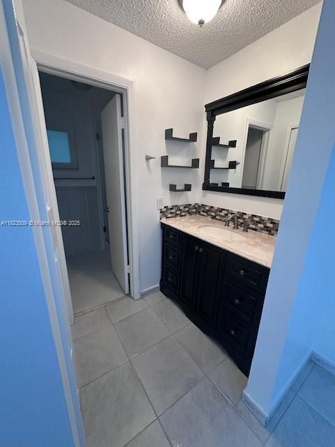 641 SW 99th Pl, Miami, FL 33174 - bathroom featuring vanity, a textured ceiling, and tile patterned floors