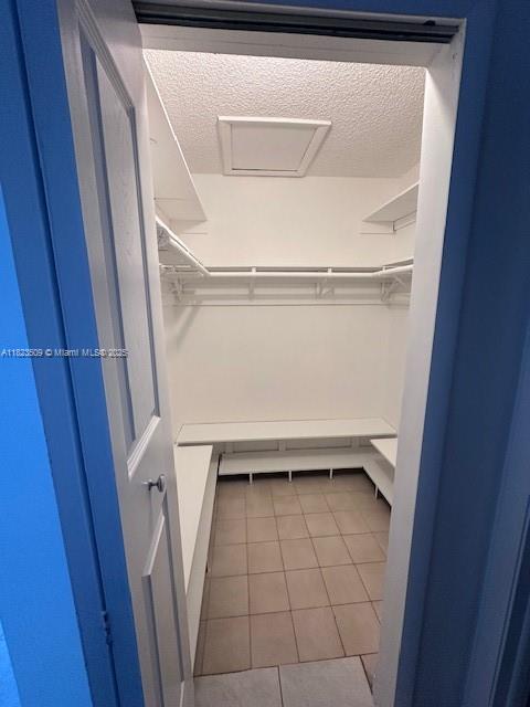 641 SW 99th Pl, Miami, FL 33174 - spacious closet with tile patterned floors and attic access