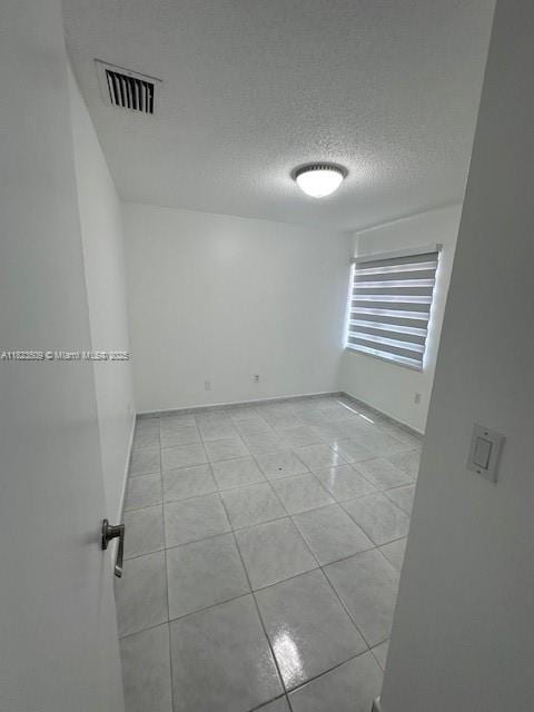 641 SW 99th Pl, Miami, FL 33174 - empty room with light tile patterned floors and a textured ceiling