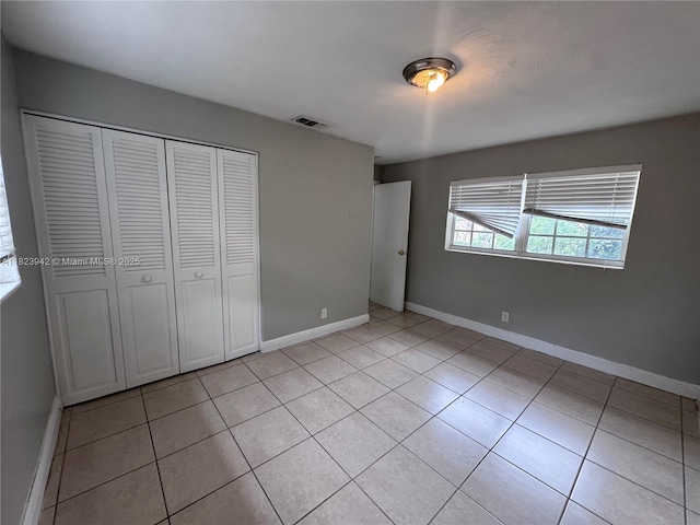 423 SW 10th Ave, Boynton Beach, FL 33435 - unfurnished bedroom featuring light tile patterned flooring and a closet
