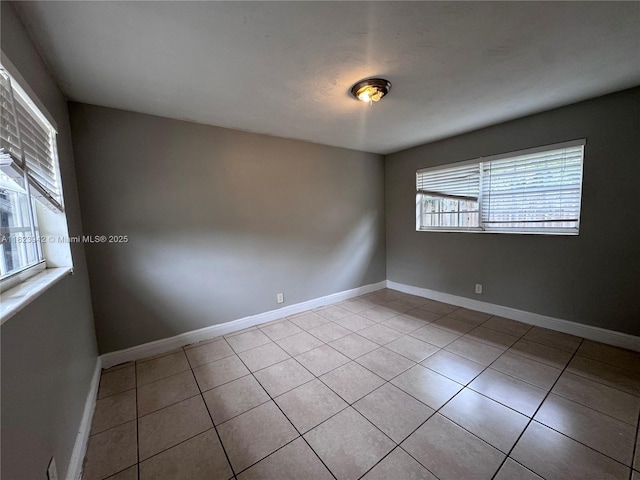 423 SW 10th Ave, Boynton Beach, FL 33435 - empty room featuring light tile patterned flooring and baseboards