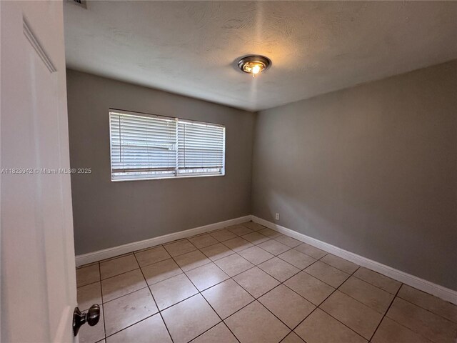 423 SW 10th Ave, Boynton Beach, FL 33435 - unfurnished room featuring light tile patterned flooring and baseboards