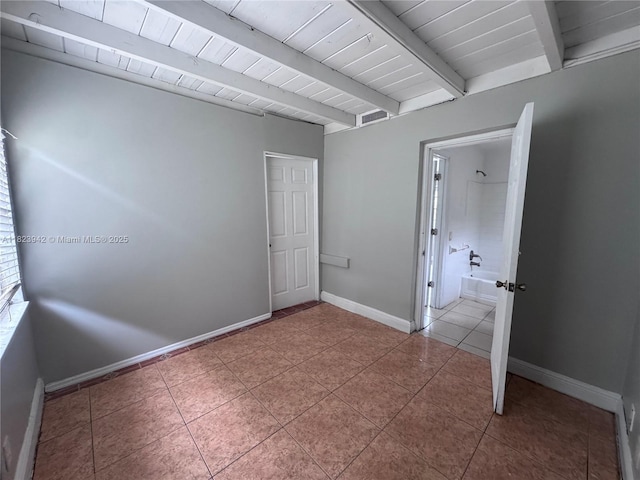 423 SW 10th Ave, Boynton Beach, FL 33435 - tiled spare room featuring baseboards and a wood ceiling with exposed beams