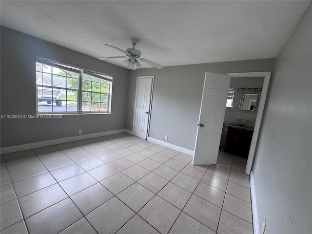 423 SW 10th Ave, Boynton Beach, FL 33435 - unfurnished bedroom with a closet, light tile patterned floors, and a ceiling fan