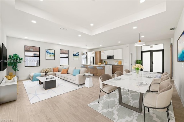 3305 18th St W, Lehigh Acres, FL 33971 - dining space featuring recessed lighting, light wood-style flooring, french doors, and a raised ceiling
