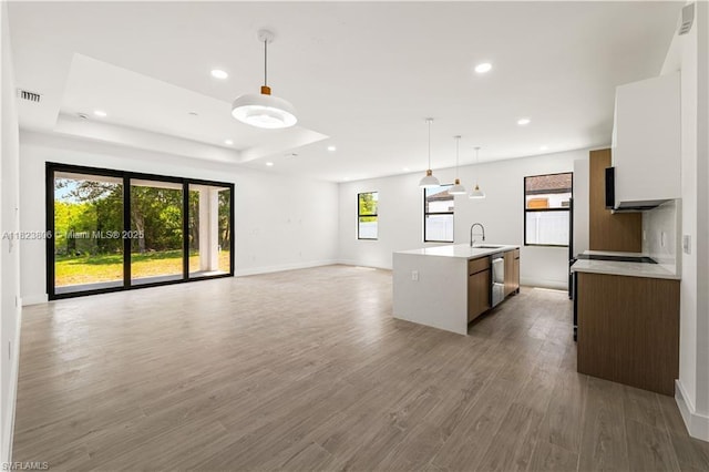 3305 18th St W, Lehigh Acres, FL 33971 - kitchen with open floor plan, light countertops, stainless steel dishwasher, recessed lighting, and pendant lighting