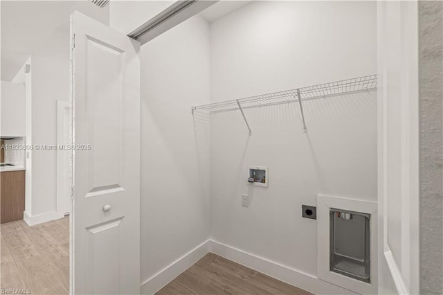 3305 18th St W, Lehigh Acres, FL 33971 - laundry room featuring washer hookup, light wood-style flooring, and hookup for an electric dryer