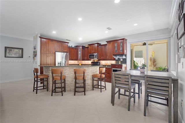 801 NW 156th Ave, Pembroke Pines, FL 33028 - kitchen with appliances with stainless steel finishes, tasteful backsplash, a breakfast bar, glass insert cabinets, and recessed lighting