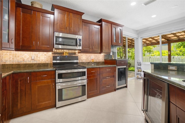 801 NW 156th Ave, Pembroke Pines, FL 33028 - kitchen with appliances with stainless steel finishes, beverage cooler, decorative backsplash, glass insert cabinets, and recessed lighting