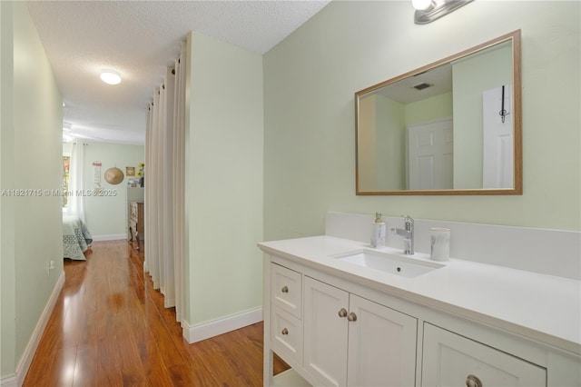 801 NW 156th Ave, Pembroke Pines, FL 33028 - bathroom featuring vanity, wood finished floors, and a textured ceiling