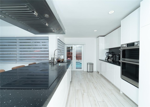 3404 Garden Ln, Miramar, FL 33023 - kitchen with extractor fan, stainless steel double oven, modern cabinets, white cabinetry, and dark countertops