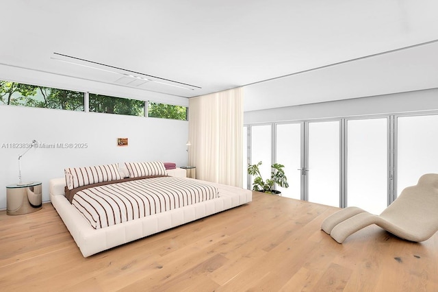 11 La Gorce Cir, Miami Beach, FL 33141 - bedroom with access to exterior and wood finished floors